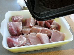 Boneless pork end rib roast, cubed and topped with rendered pork fat.