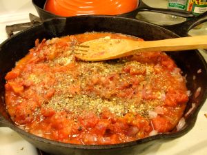 Preparing the sauce with spices.