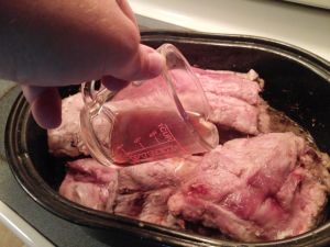 Pre-cooking the ribs in a covered roasting pan with a nice scotch ale and water from rehydrating the dried peppers.