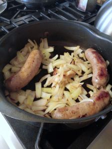 Browning onions and cooked Italian sausage.