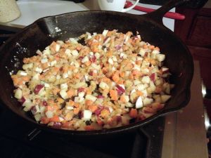 Sautéing vegetables for pie filling.