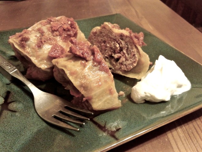 Gołąbki with tomato sauce, served with sour cream.