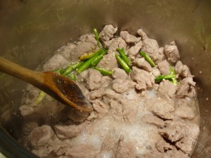 Add baking soda and chilis to cooked, stewing pork.